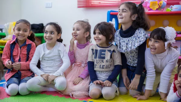 Participants laugh as they play games in a War Child child-friendly space.