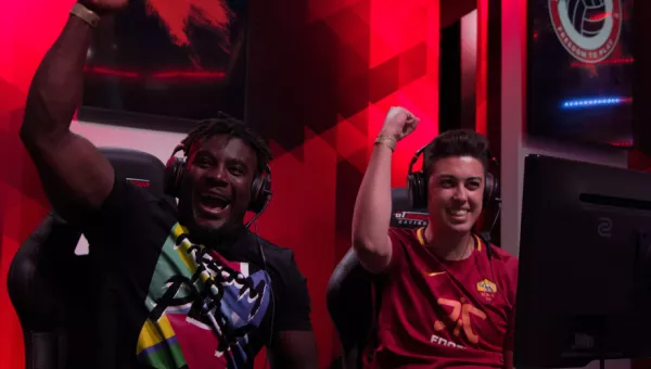 Gamers cheer as they play football gaming tournament for War Child.