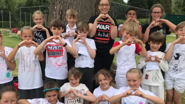 A group of school children in their handmade War Child t-shirts as part of their fundraising project