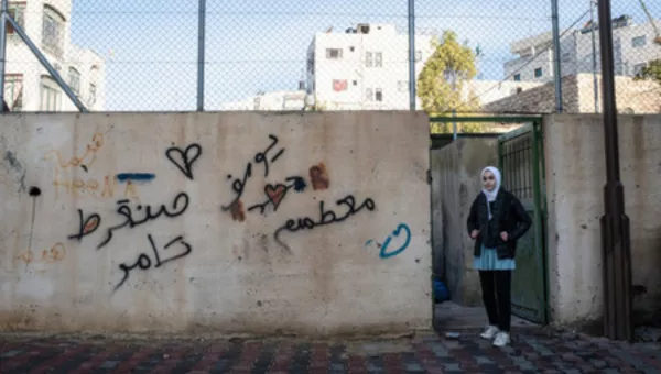 A girl standing in a doorway in Gaza. 