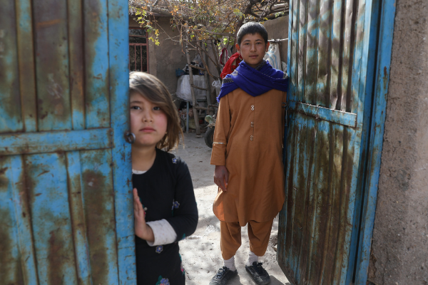 Participant Hassan with his sister outside their home in Afghanistan.