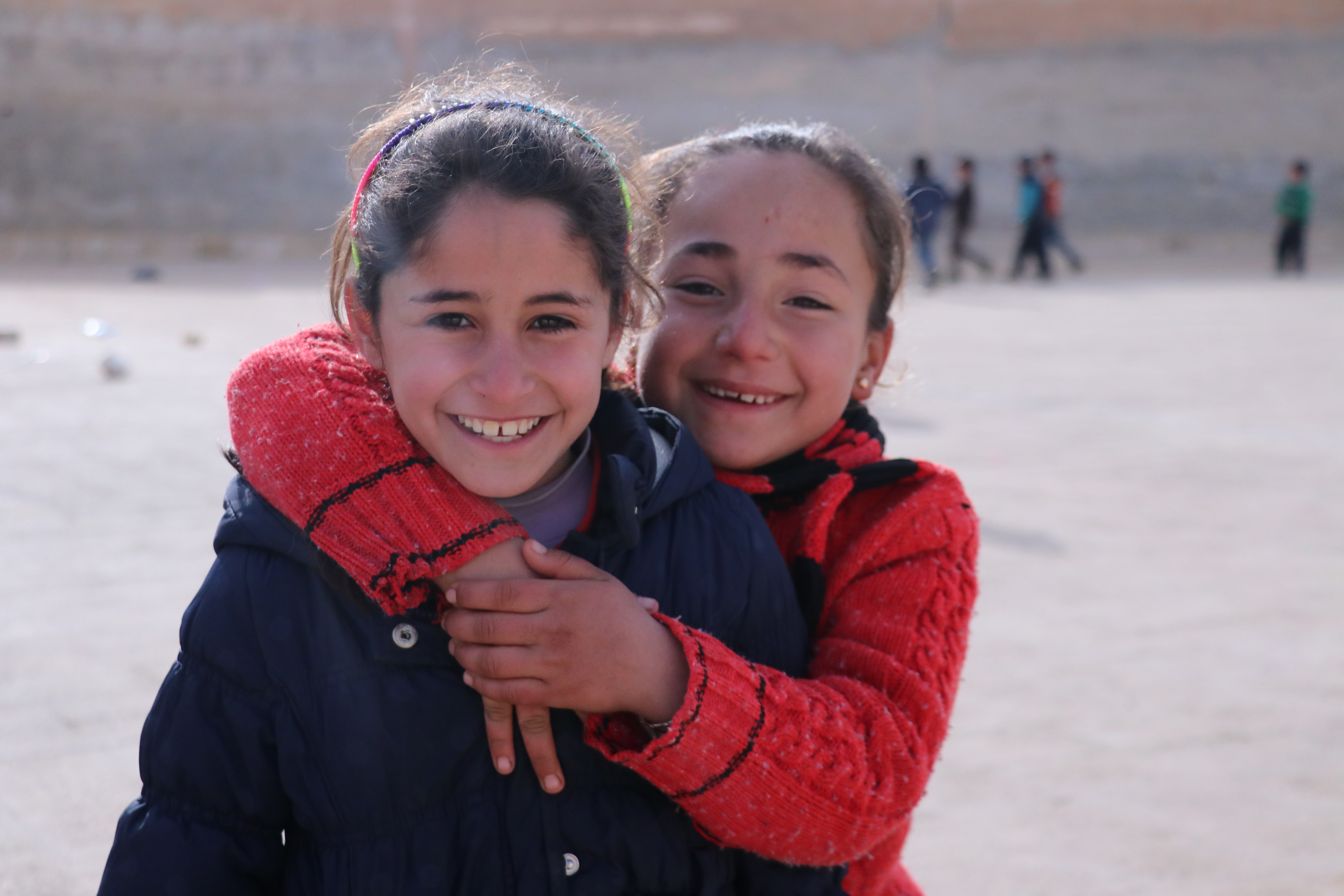 2 children smiling, Syria. 