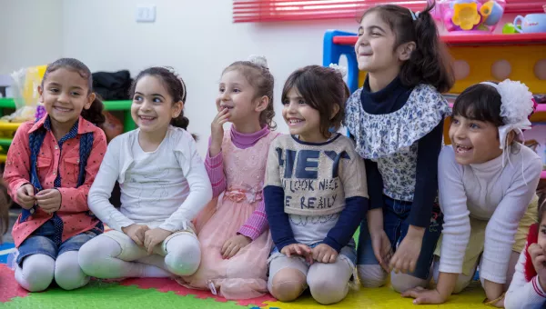 Participants laugh as they play together in a War Child child-friendly space in Jordan.