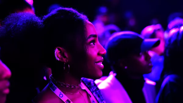 Fan smiles watching performance as part of War Child's BRITs Week.