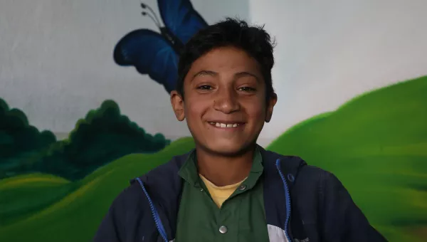 Jawad smiles at one of War Child's centres in Afghanistan after being reunited with his family.