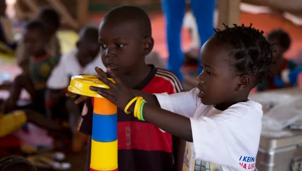 Two children playing together at a War Child project in the Central African Republic.