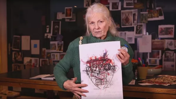 Vivienne Westwood holds the artwork printed on t-shirts made in collaboration with War Child.