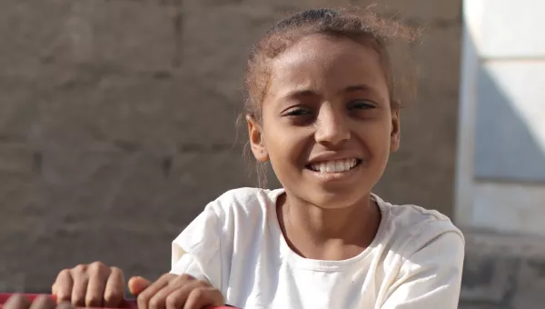 Yemeni girl smiles to camera.