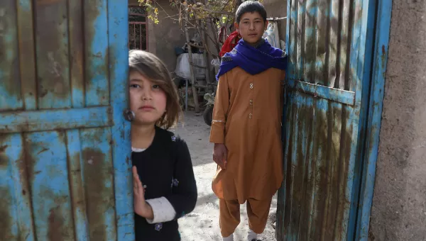 Participant Hassan at home with his little sister in Afghanistan.