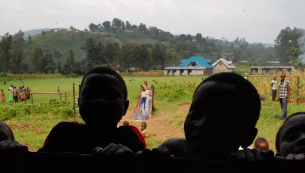 Children in the Democratic Republic of Congo peer through a school window.