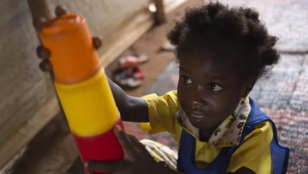 A girl playing with building blocks. 