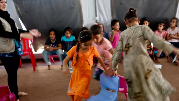 Young girls play a game at a child-friendly space that is run by War Child at a displacement camp in Iraq.