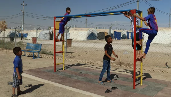 Boys playing on a climbing frame. 