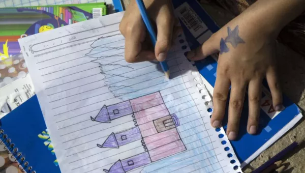 Nalin drawing a house. 