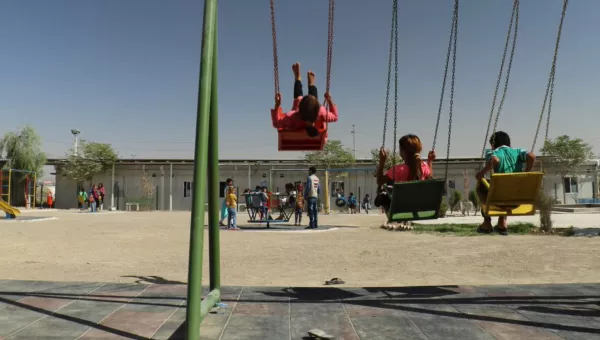 Children playing on the swings. 