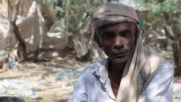 Noor Hassan, 45 years old, poses for a photograph in a camp in Yemen