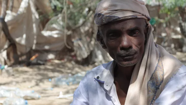 Noor Hassan, 45 years old, poses for a photograph in a camp in Yemen