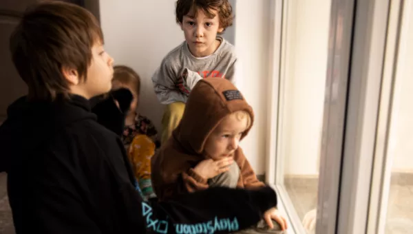 Platon sitting with his family, Ukraine.