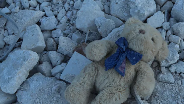 A childs teddy bear in the rubble of a colapsed building, Syria.