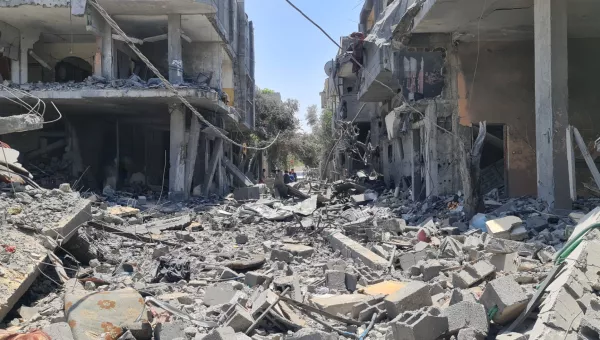Destroyed buildings and rubble-filled street in Gaza.