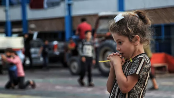 Girl standing in a playground in Gaza. 