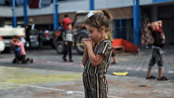 Girl standing in a playground in Gaza. 