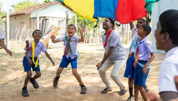 Children playing with a parachute in Sri Lanka.