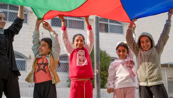 Children playing with a parachute.