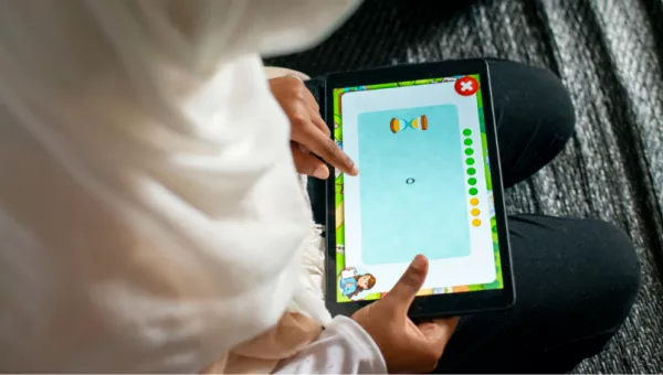 A child playing a Can't Wait to Learn game in Lebanon.