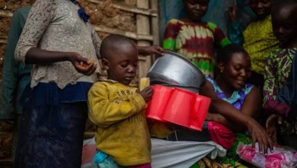 Child in DRC with the items they recieved from WC.