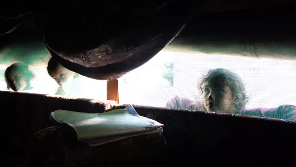 A girl looking through a window.