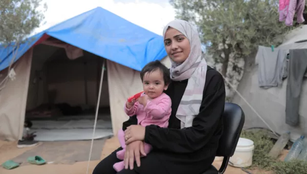 A woman holding a baby.