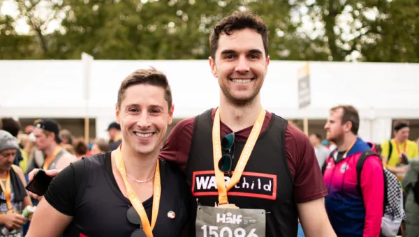 Two runners standing side by side smiling
