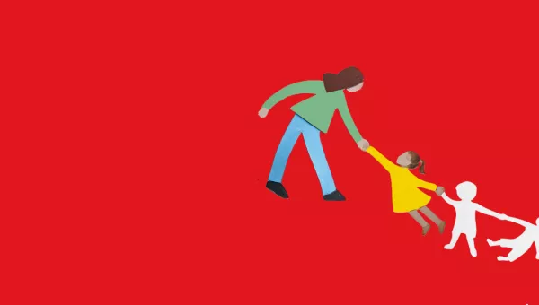 An adult holding a childs hand on a red background