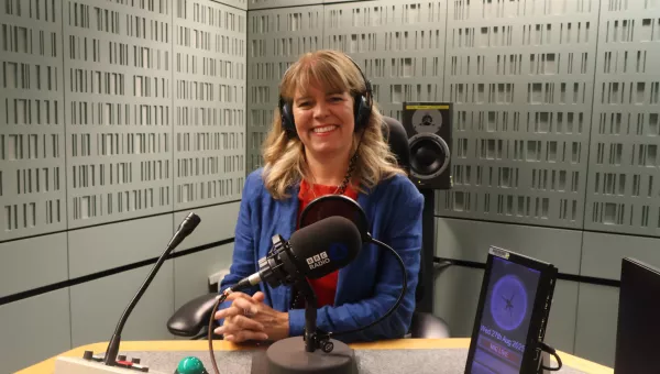 Claudia Hammond sits smiling in a recording studio