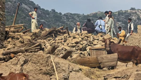 Afghan standing on top of broken homes