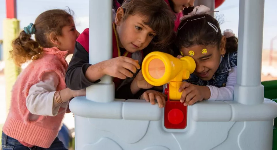 Girls play in a playhouse in a child-friendly space in Jordan. Photo: Rosie Lyse Thompson 