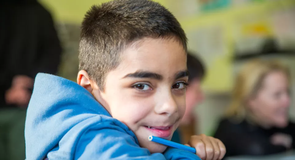 Child smiling in classroom, Ukraine.