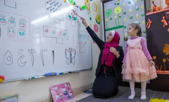 Education facilitator in Jordan teaching students in a War Child temporary learning space.