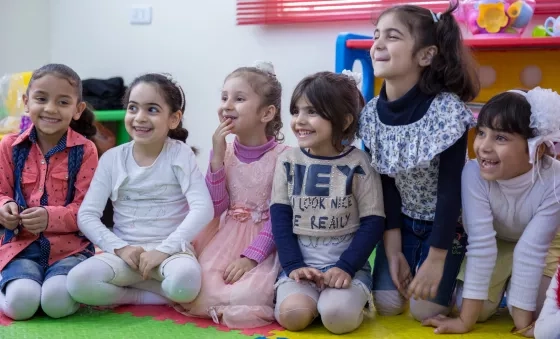 Participants laugh as they play together in a War Child child-friendly space in Jordan.