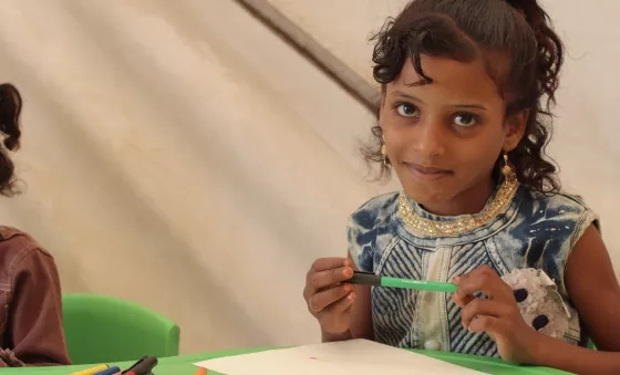 Girl in Yemen completes her drawing at a War Child centre.