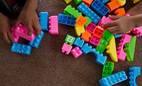Children play with colourful building blocks in a War Child child-friendly space in Iraq.