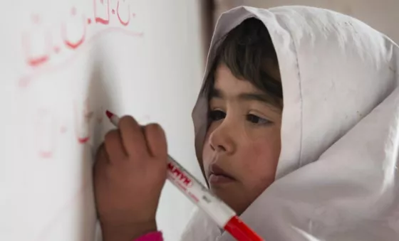 A girl is learning the alphabet in a War Child class in Afghanistan. Photo Kiana Hayeri / War Child UK