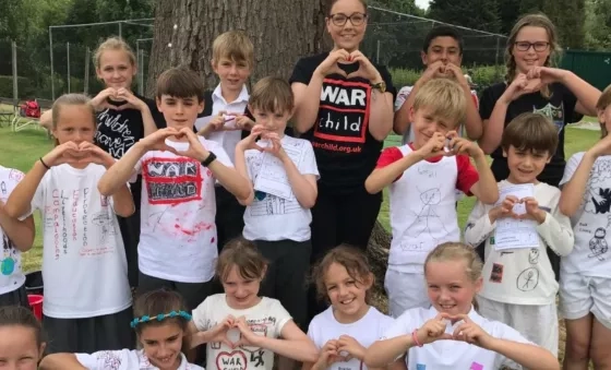 A group of school children in their handmade War Child t-shirts as part of their fundraising project