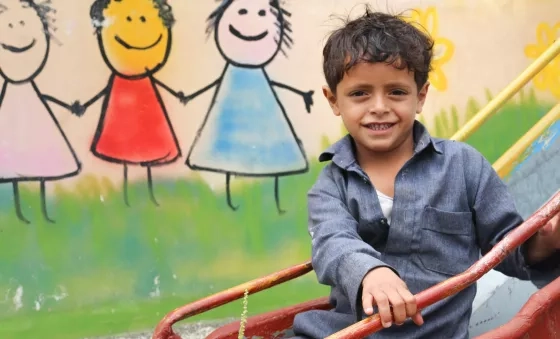 Participant plays on a slide outside one of War Child’s centres in Yemen.