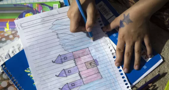 Nalin drawing a house. 