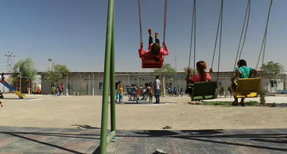 Children playing on the swings. 