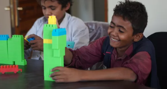 Sharaf playing with building blocks at a War Child centre in Yemen