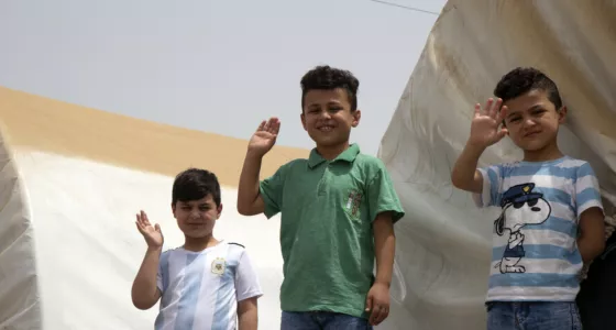 Children waving at a camp in Iraq. 