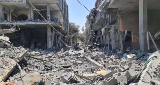 Destroyed buildings and rubble-filled street in Gaza.
